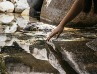Close-up of a hand in the river water