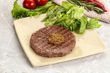 Frilled beef burger cutlet with iceberg