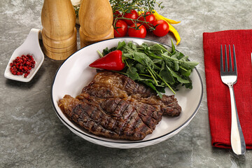 Grilled chuck roll steak with arugula