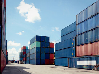Stack of cargo container box in logistic shipping yard whit blue sky on sunny day
