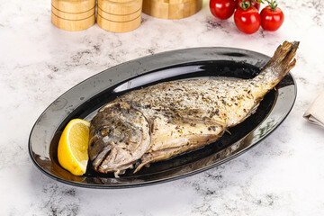 Baked Dorado fish served lemon