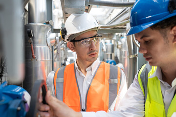 Two Engineers are inspecting a large building or industrial facility's cooling system for the air...