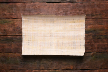 Ancient Egypt papyrus blank letter scroll with copy space on the old flat lay table background. Old...