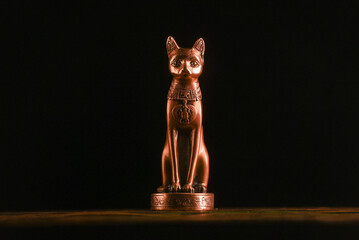 Ancient Egypt goddess Bast (Bastet) silluethe in the lights close up.