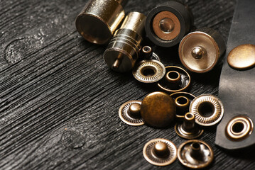 Alfa buttons and leather craft manual hand press attachments close up background. Top view.