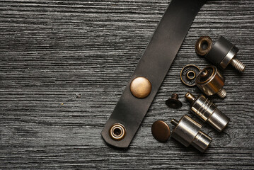 Alfa buttons and leather craft manual hand press attachments close up background. Top view.