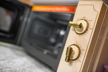 Modern microwave oven in the retro style with open door close up background.