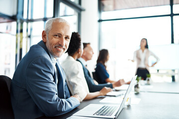 Portrait, businessman and presentation in smile, boardroom and meeting. Mature man, laptop and office for strategy, campaign and corporate or plan, employees and collaboration in coworkers or manager