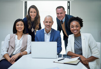Portrait, diversity and group of businesspeople by desk for collaboration, laptop and support. Global staff, smile and tech in modern office for cooperation with strategy meeting and sitting together - obrazy, fototapety, plakaty