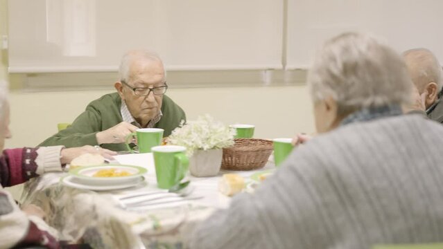 Senior people eating in a dinning room in a geriatric