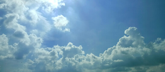 The wide view of the blue sky and thick white clouds is enchanting