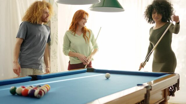 Woman applauding a friend while playing pool