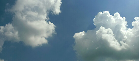 The wide view of the blue sky and thick white clouds is enchanting