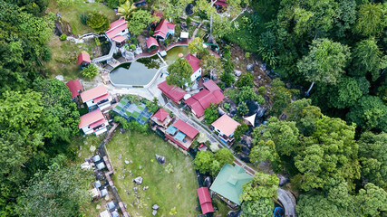 Aerial view of the Hill Resort surrounded by the rainforest in Lenggong during sunrise.
