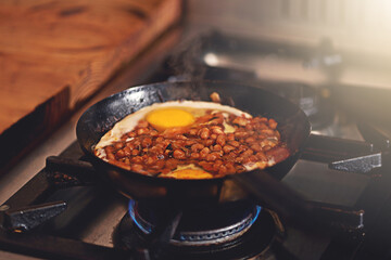 Cooking, food and eggs in pan in kitchen on heat for meal prep for dinner, supper and lunch in...