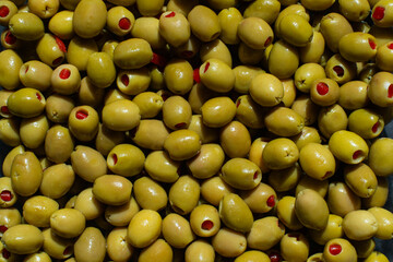 Juicy salted green olives, stuffed with red peppers