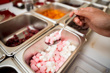 Young woman in the workshop during a lesson on making handmade chocolates and sweets