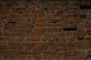 The wall is made of red brick. The texture.