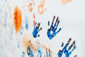 The paint of hands and drawing of kids craft show artist skill using blue and orange color in...