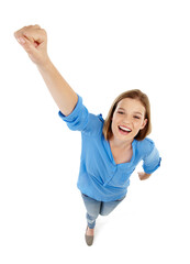 Girl, fist and power or success in studio for confidence, motivation or superhero pose for learning. Portrait of excited student or winner in top view with yes, victory or soaring on white background