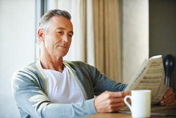 Mature, man and newspaper for reading in house, relax and information or articles in morning with...