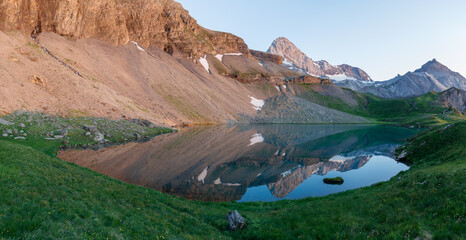 Fantastic sunrise panorama of picturesque little lake in the Swiss alps, Fluhsee, close to Lenk in...