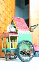 Low angle view. A colorful wooden miniature wagon equipped with a loudspeaker as one of the traditional Betawi accessories in Indonesia.