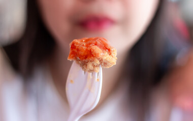 Woman eating fried chicken blur background, Street food thailand