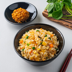Chinese Vegetable Fried Rice in a Bowl with Side Dish on White Background