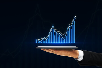 Close up of male hand holding smartphone with creative growing forex chart on dark background with mock up place. Trade, finance and stock concept.