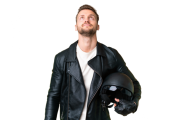 Young caucasian man with a motorcycle helmet over isolated chroma key background and looking up