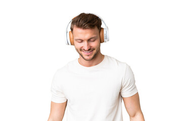 Young handsome caucasian man over isolated chroma key background listening music