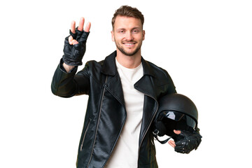 Young caucasian man with a motorcycle helmet over isolated chroma key background happy and counting...