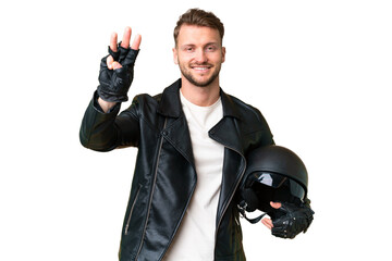 Young caucasian man with a motorcycle helmet over isolated chroma key background happy and counting three with fingers