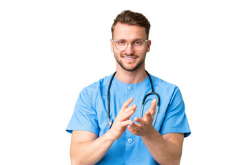 Young nurse man over isolated chroma key background applauding after presentation in a conference