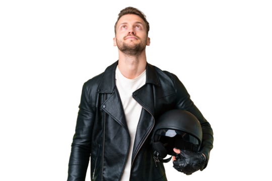 Young caucasian man with a motorcycle helmet over isolated chroma key background and looking up