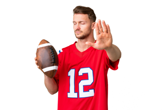 Young caucasian man playing rugby over isolated chroma key background making stop gesture and disappointed