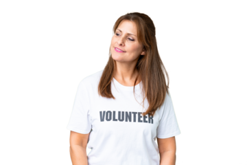 Middle age volunteer woman over isolated background looking to the side and smiling