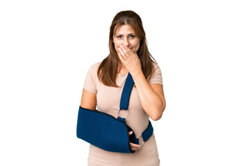 Middle age with broken arm and wearing a sling over isolated background happy and smiling covering...