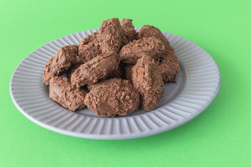 Belgian milk chocolate flakes truffles on a green background