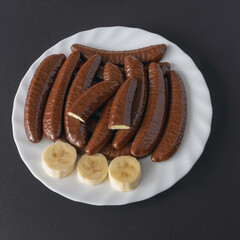 Chocolate covered banana flavored slices on a plate top view