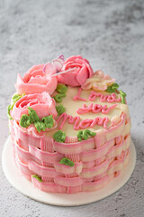 Mothers Day celebration cake with Love you Mom text, isolated on table. Space for text.