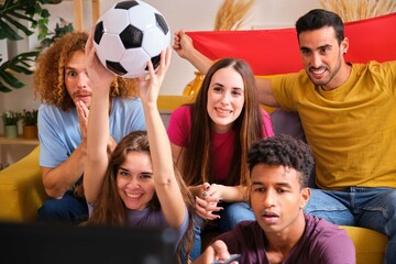 Group of friends stared intently the soccer close World Cup game match at home.