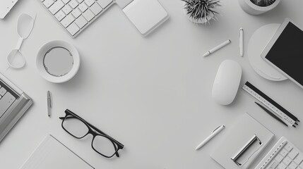 Top view of an organized desk with office essentials in a monochrome color scheme, emphasizing a clean and modern workspace