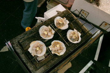 Seafood shell and fish cooked on a grill at the Osaka fish market in Japan.