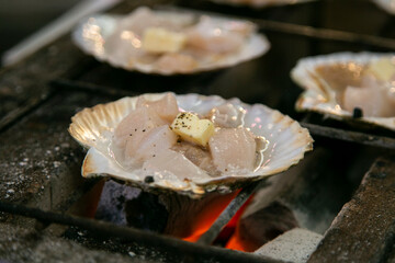 Seafood shell and fish cooked on a grill at the Osaka fish market in Japan.