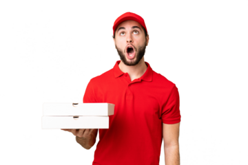 pizza delivery man with work uniform picking up pizza boxes over isolated chroma key background looking up and with surprised expression