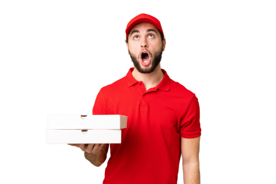pizza delivery man with work uniform picking up pizza boxes over isolated chroma key background looking up and with surprised expression - Powered by Adobe