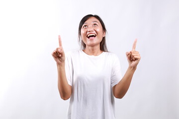 Amused young asian woman introduce new product sharing promo with you, raise hands pointing fingers...
