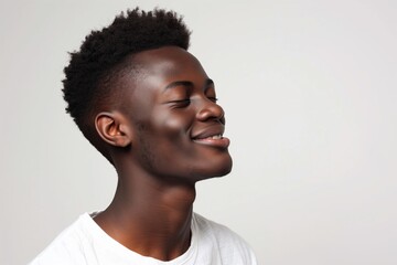 Obraz premium Joyful Young Black Man Smiling with Eyes Closed